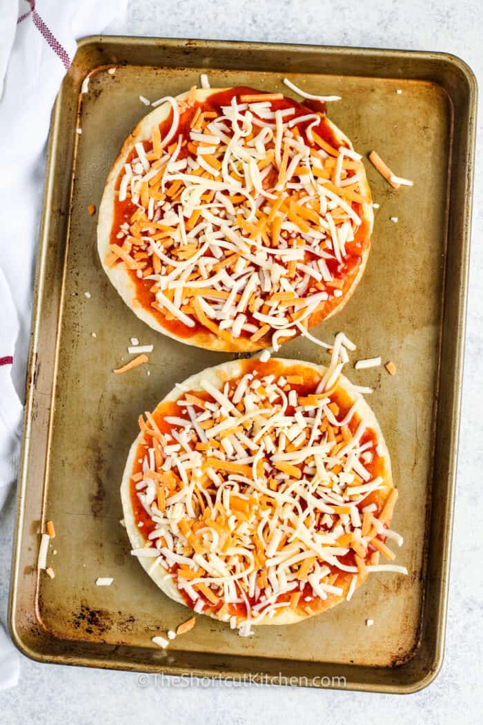 adding cheese to tortilla to make Copycat Taco Bell Mexican Pizza