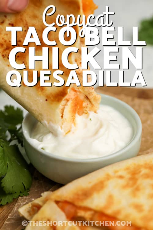 dipping copycat taco bell chicken quesadillas in sauce with text