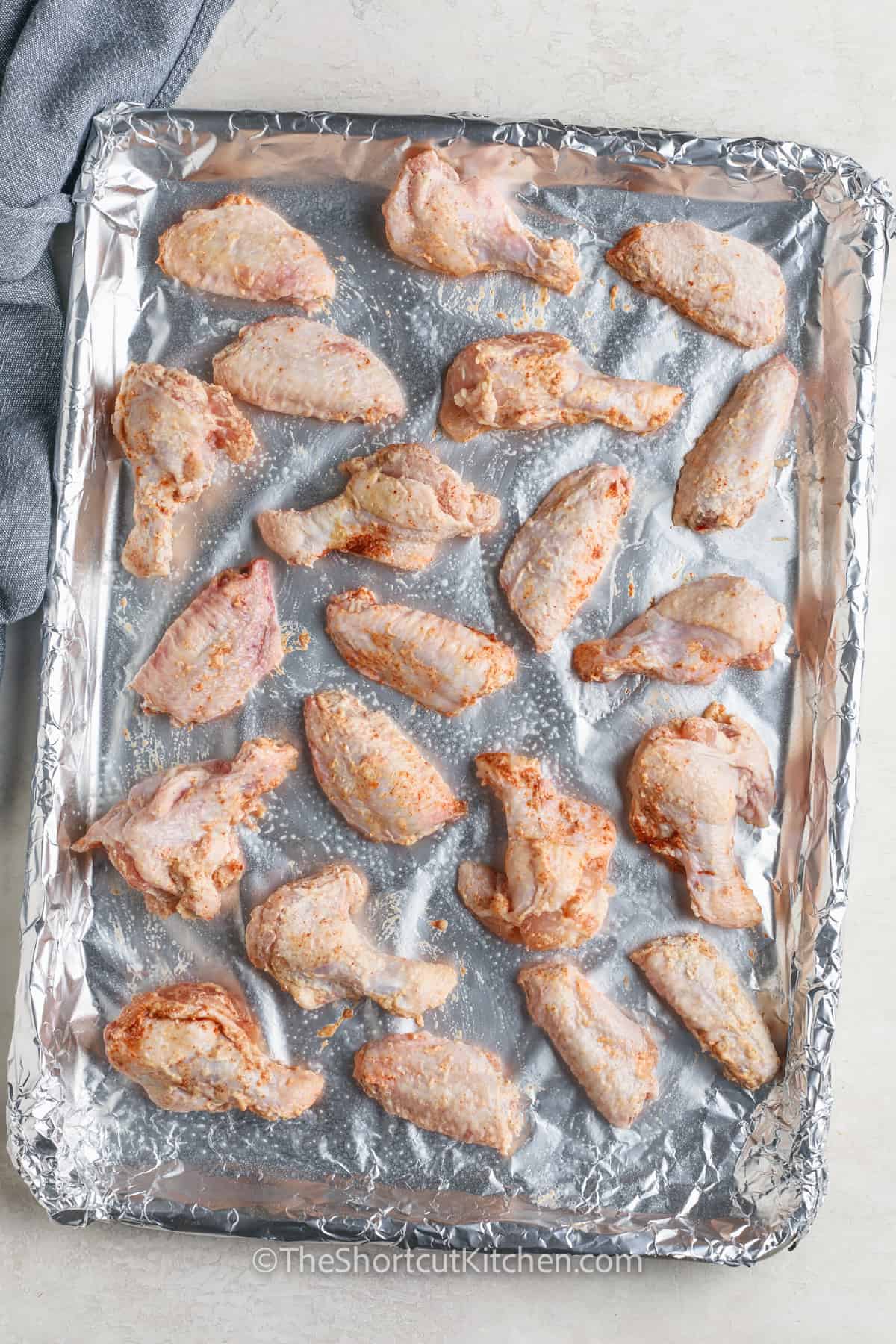 chicken on a sheet pan to make Oven Baked Chicken Wings