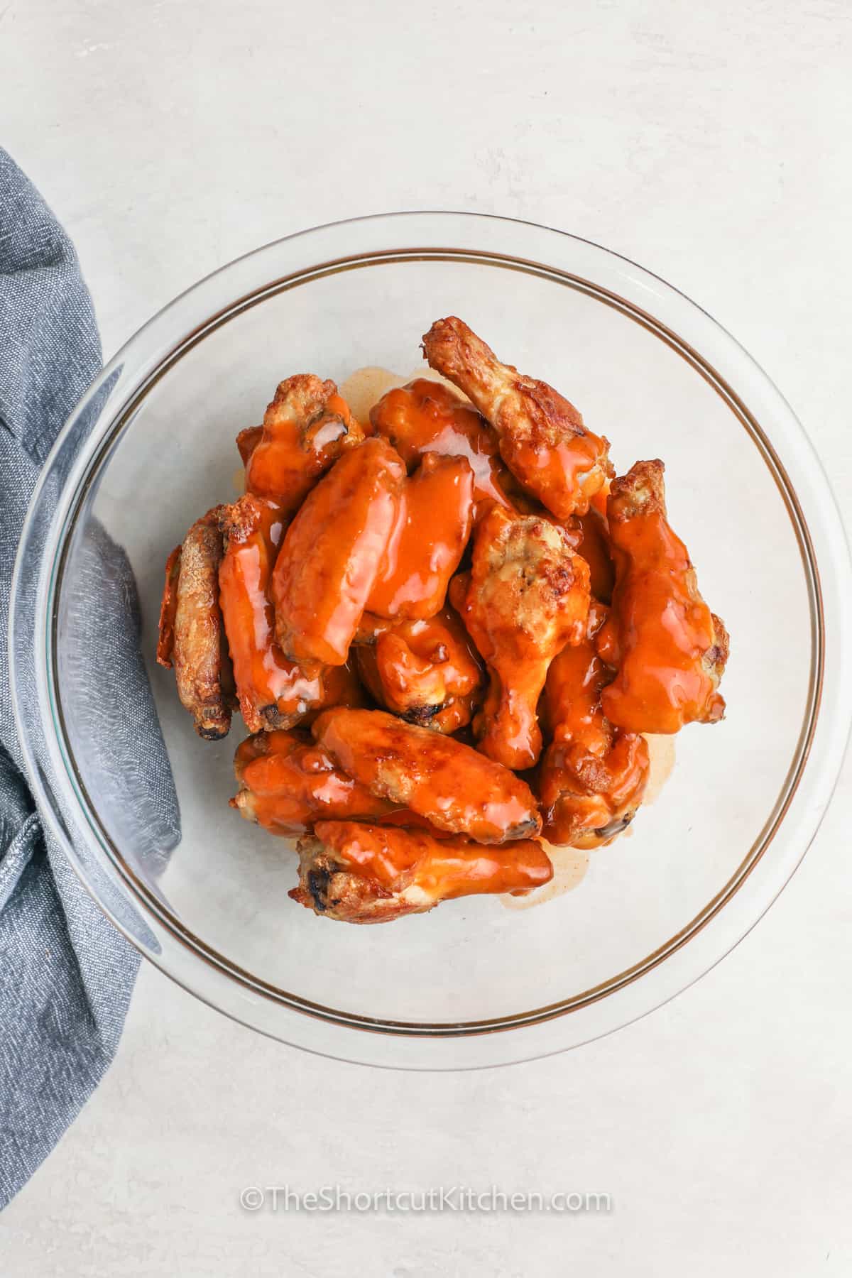 coating chicken in sauce to make Oven Baked Chicken Wings