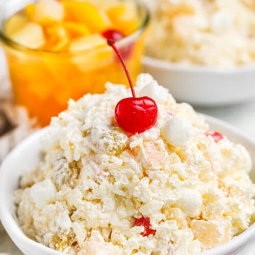 Glorified Rice in a bowl with fruit cocktail in the back