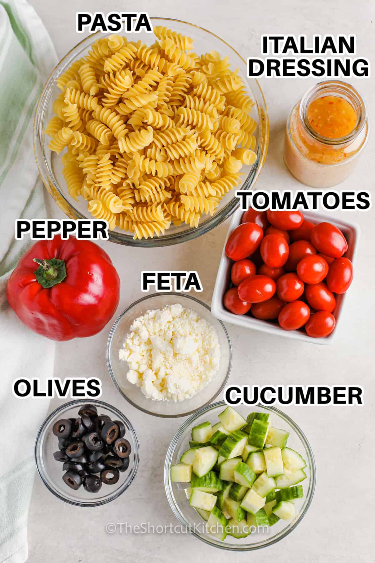 pasta , Italian dressing , tomatoes , feta , pepper , cucumber and olives with labels to make Easy Pasta Salad