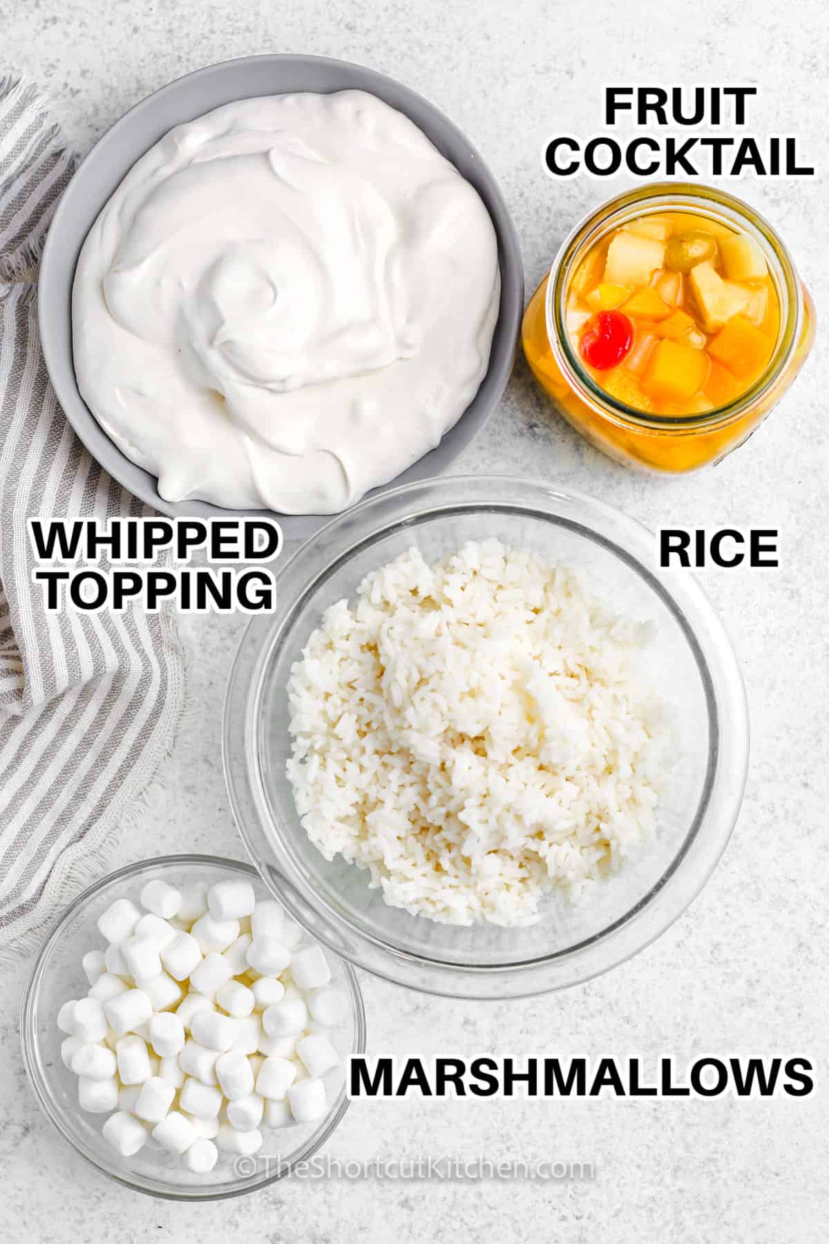 whipped topping , fruit cocktail , rice and marshmallows to make Glorified Rice with labels