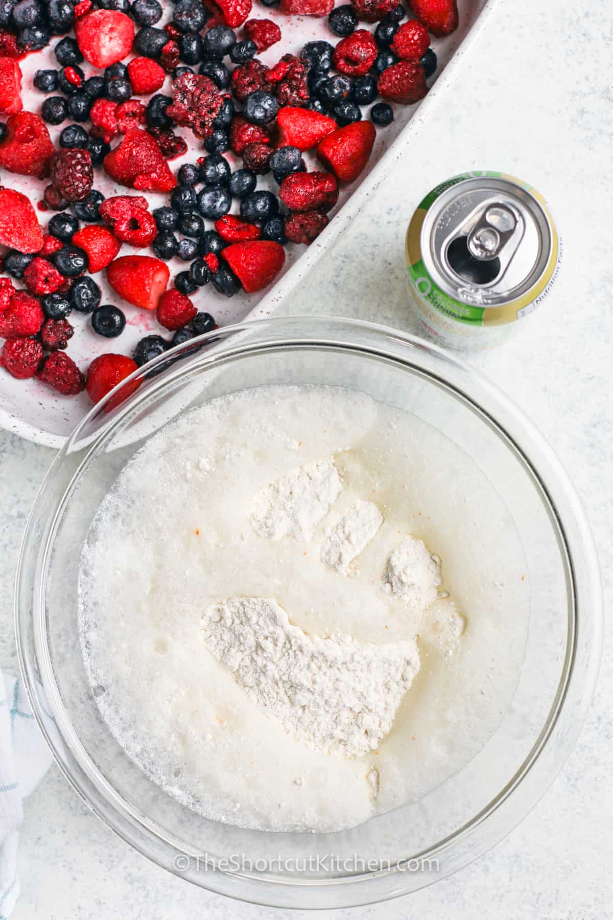 adding sprite to cake mix to make Mixed Berry Dump Cake