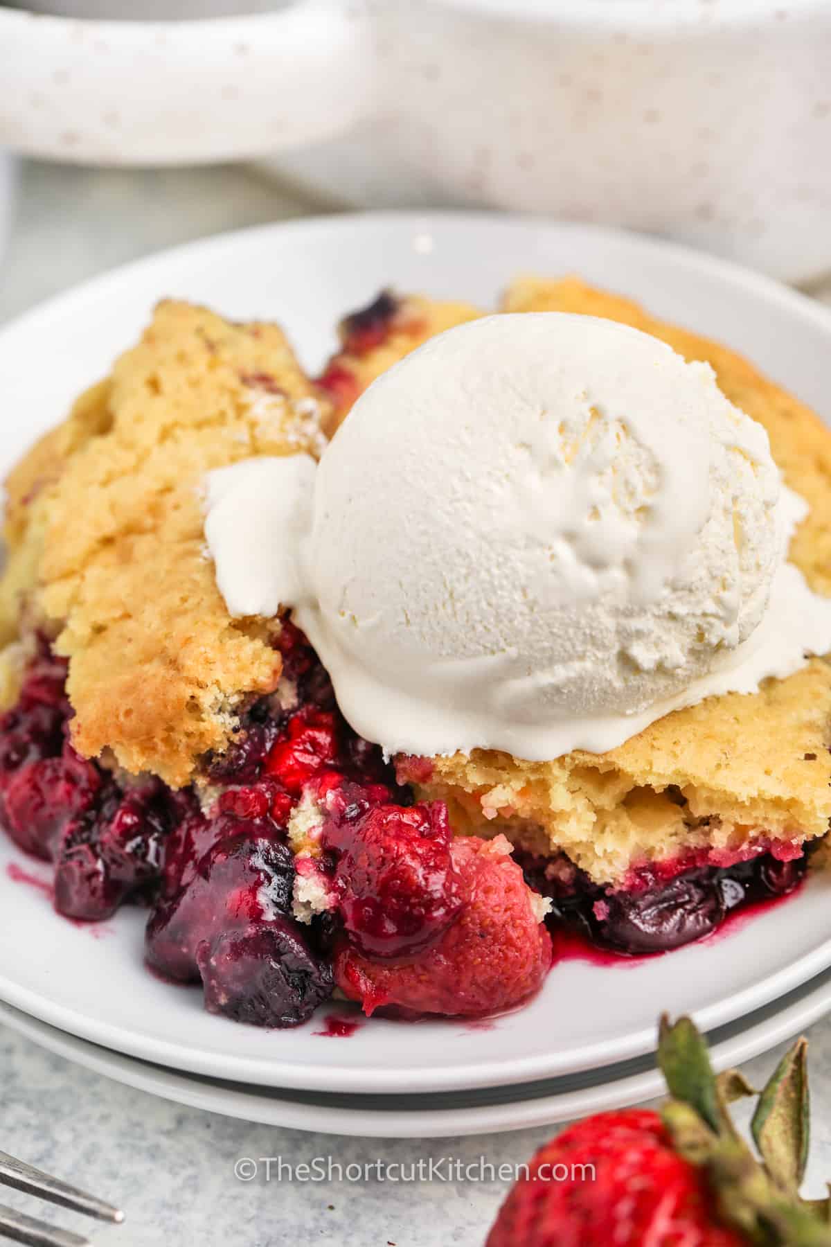 close up of Mixed Berry Dump Cake with ice cream