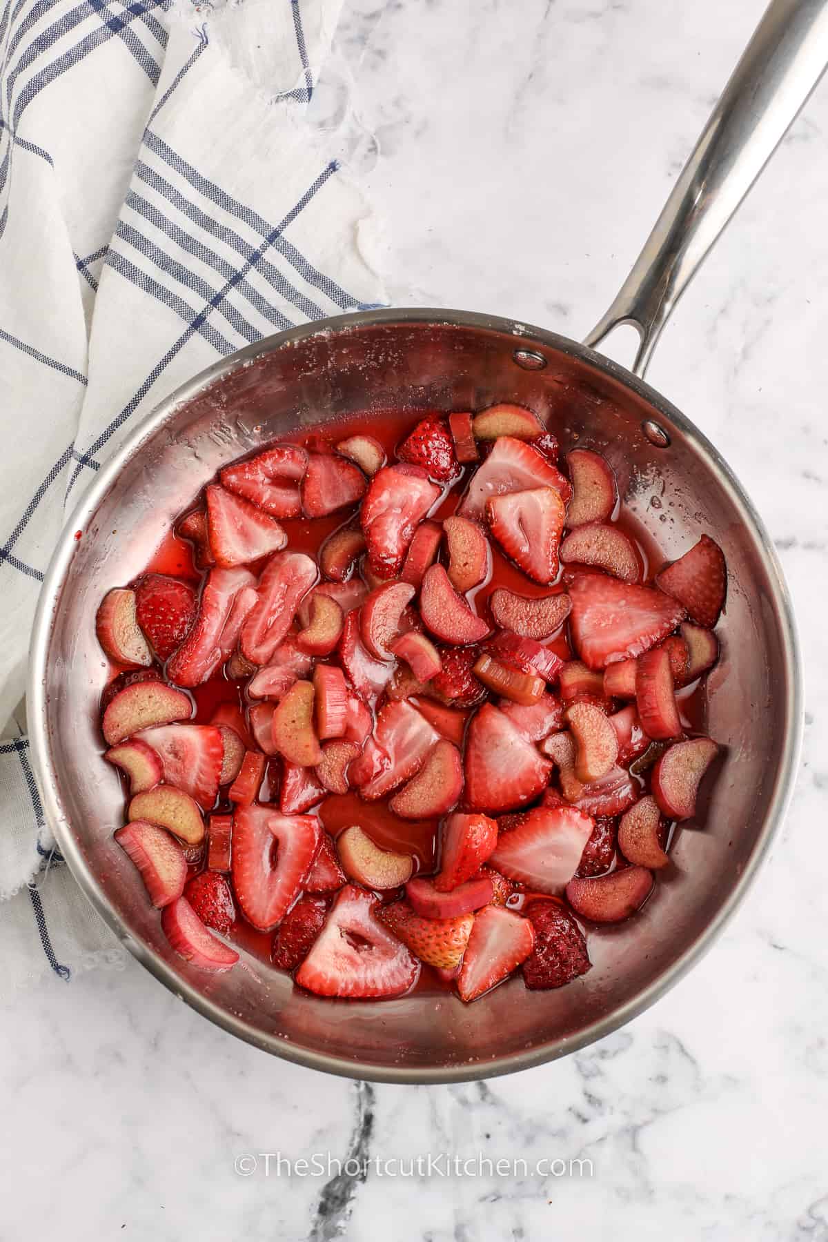 strawberries and rhubarb cooking in the pan to make Strawberry Rhubarb Cobbler