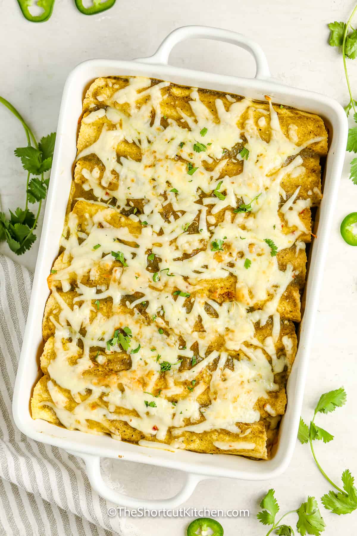 easy chicken enchiladas in a dish topped with cilantro