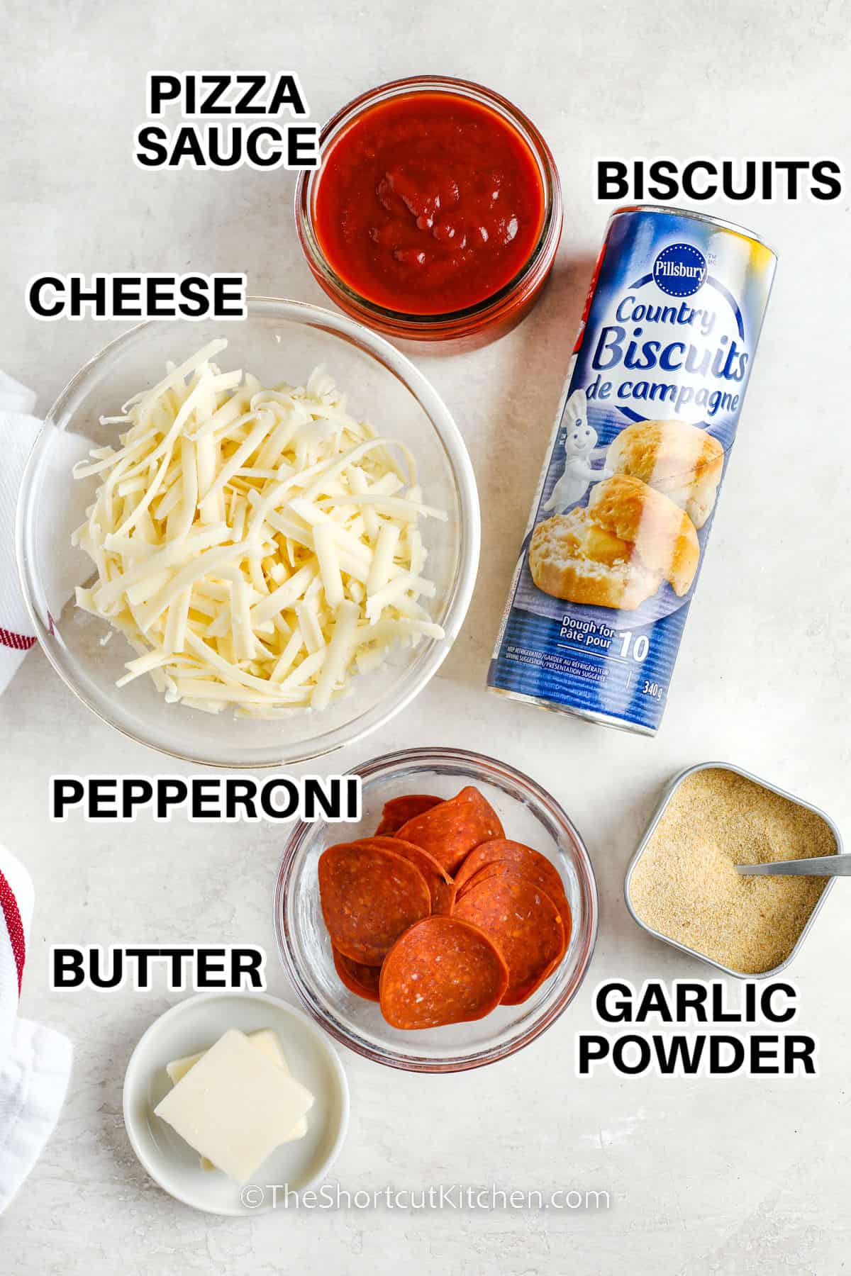 pizza sauce , cheese , biscuits , garlic powder , pepperoni and butter with labels to make Cheesy Bubble Pizza Recipe