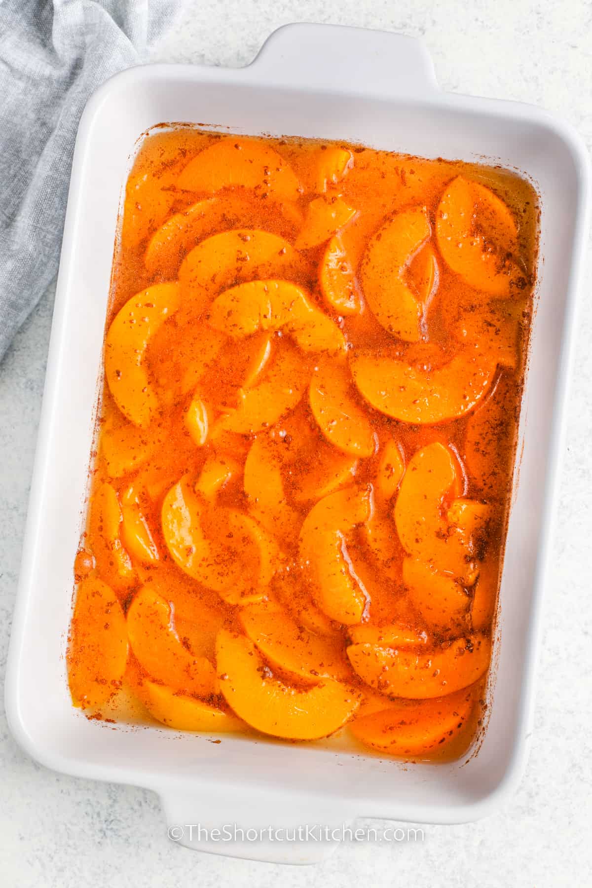 peaches in a casserole dish to make Peach Dump Cake