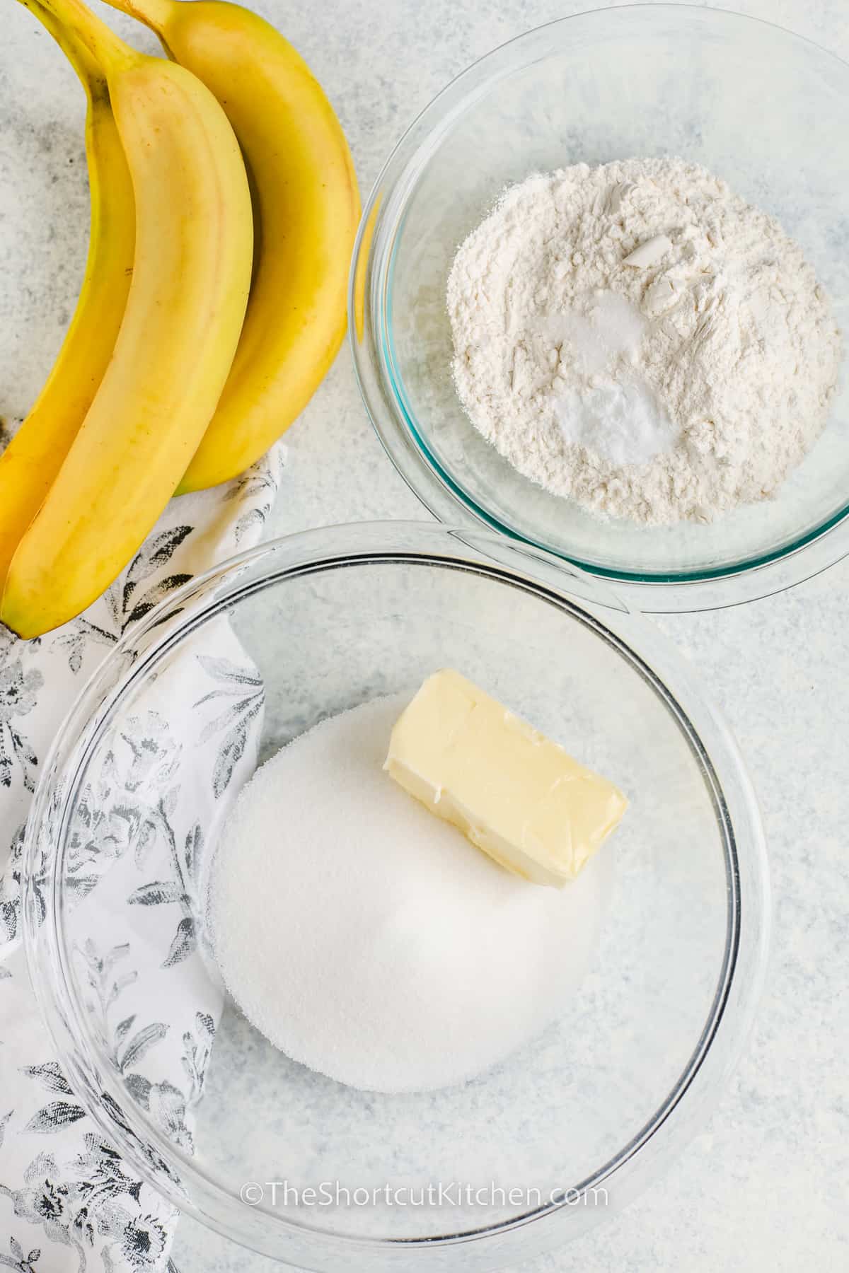 adding dry ingredients in one bowl , and butter with sugar in another to make Banana Bars