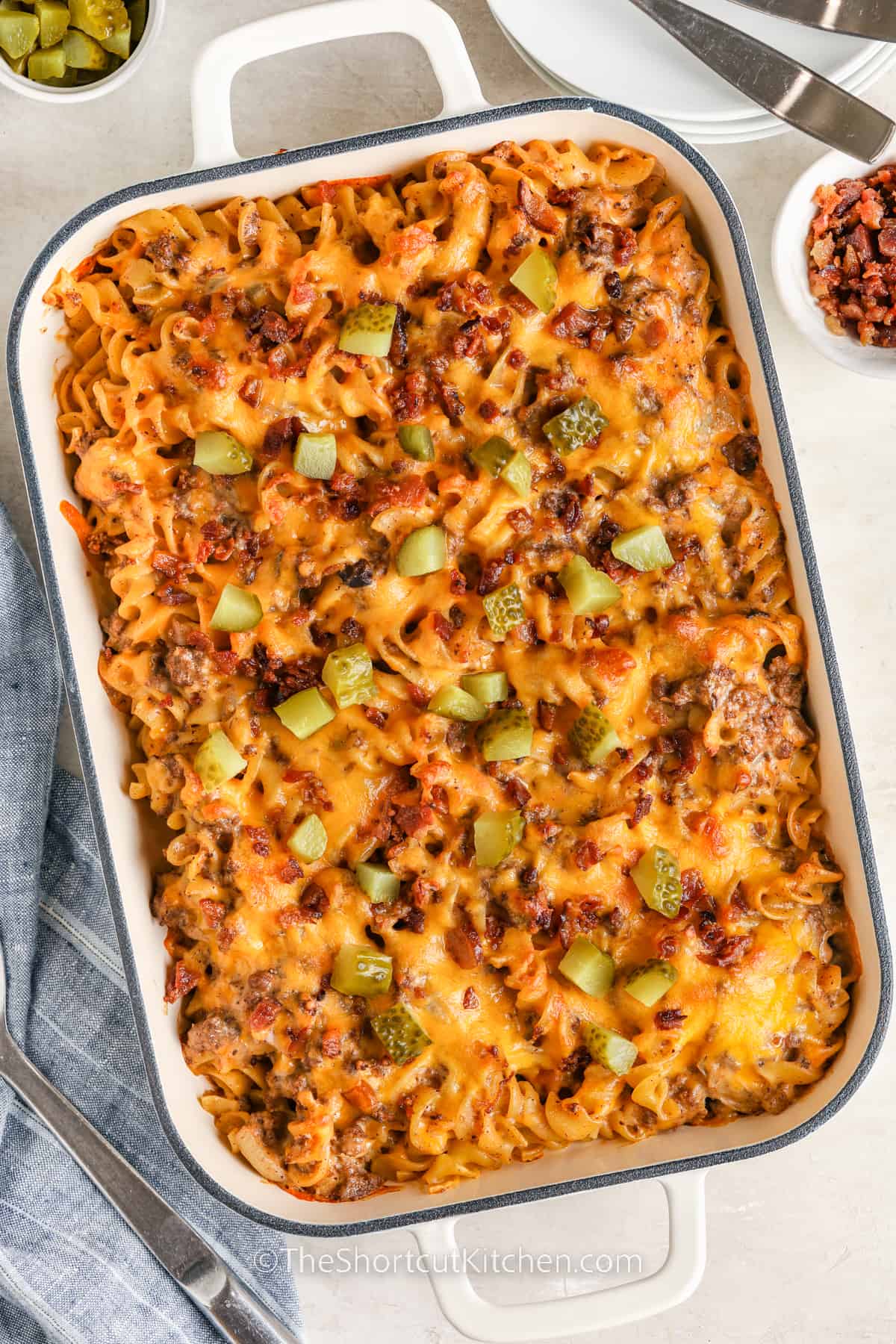 Baked bacon cheeseburger casserole topped with chopped pickles