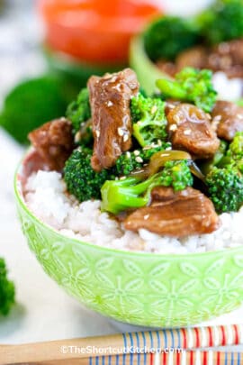 a bowl of rice topped with crockpot beef and broccoli