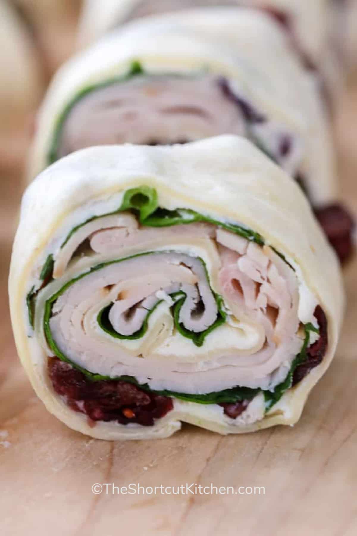 cranberry turkey pinwheels on a wooden board