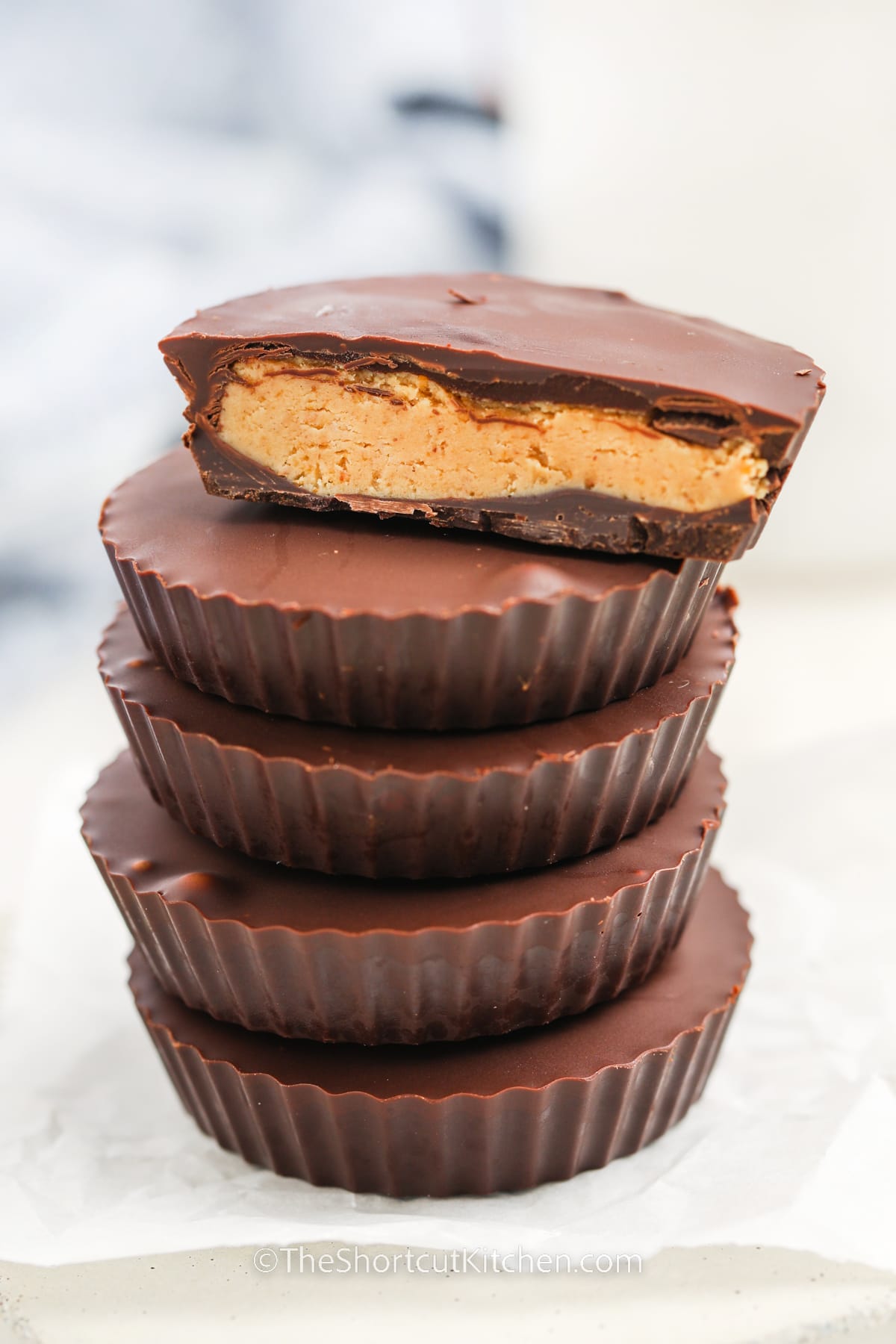 Peanut butter cups are the ultimate no bake dessert, and this easy recipe nails the balance of creamy, sweet, and salty. The smooth peanut butter filling is hugged by a shell of rich chocolate, creating that iconic bite. With simple ingredients and a quick chill in the freezer, you’ll have a batch of homemade treats that beat anything store-bought. #theshortcutkitchen Five homemade peanut butter cups stacked
