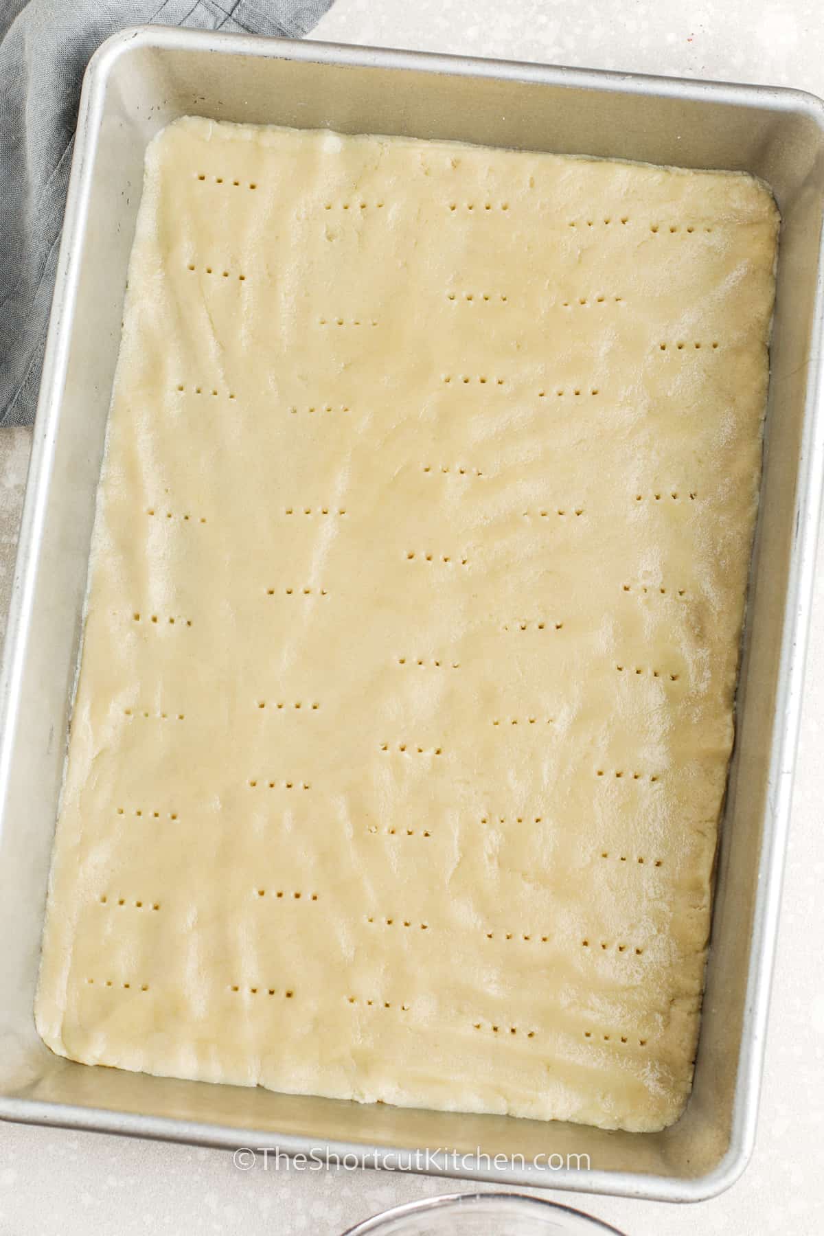 sugar cookie dough rolled out on a baking sheet