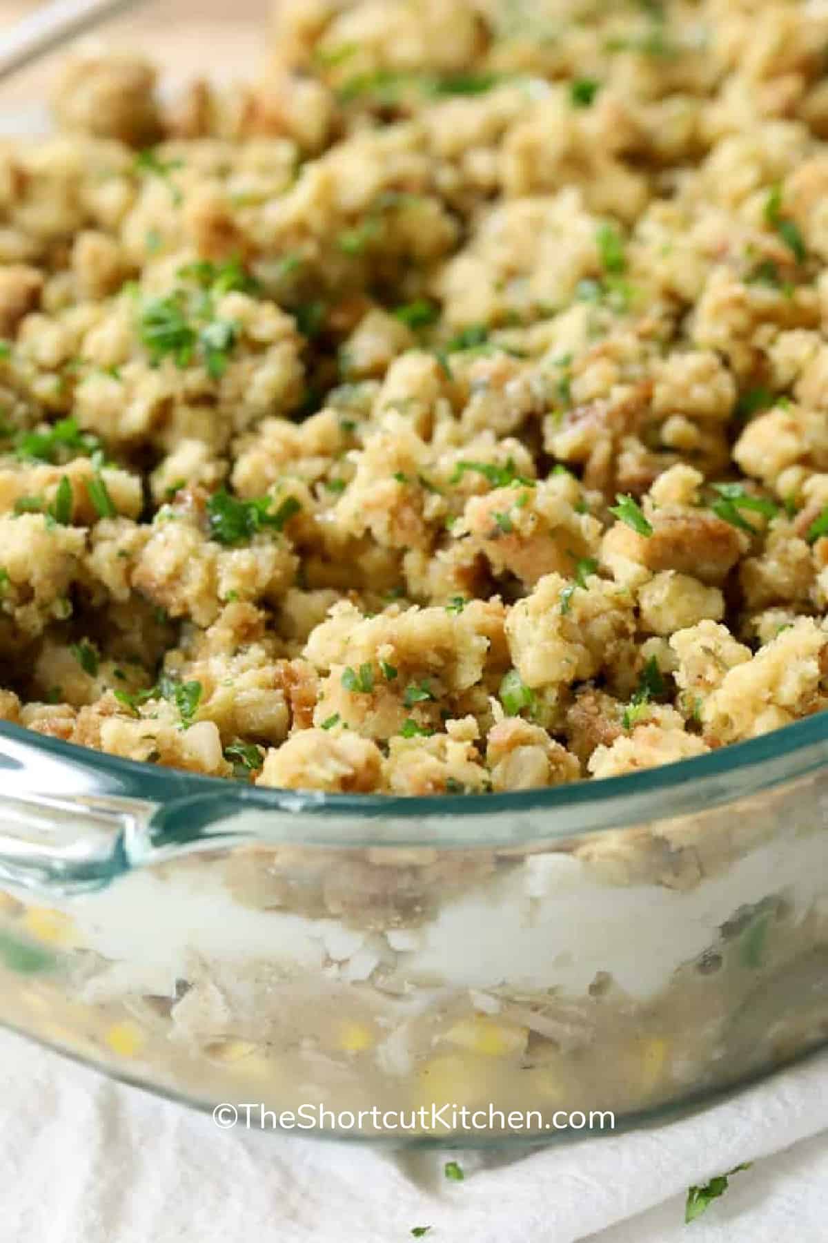 Leftover turkey casserole recipe in a clear casserole dish garnished with parsley