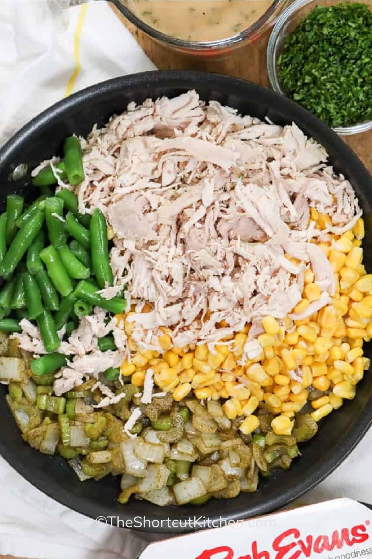 Leftover turkey casserole is an effortless way to turn holiday or weeknight leftovers into a show-stopping dish. The combination of tender turkey, flavorful sautéed onions and celery, sweet corn, and green beans under creamy mashed potatoes and golden stuffing creates a balanced and satisfying meal that is rich, comforting, and sure to please every palate. #theshortcutkitchen Ingredients to make leftover turkey casserole recipe in a pot