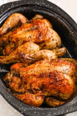 Two baked Cornish Hen in a roasting pan