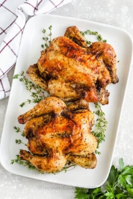 Two baked Cornish Hen on a serving platter