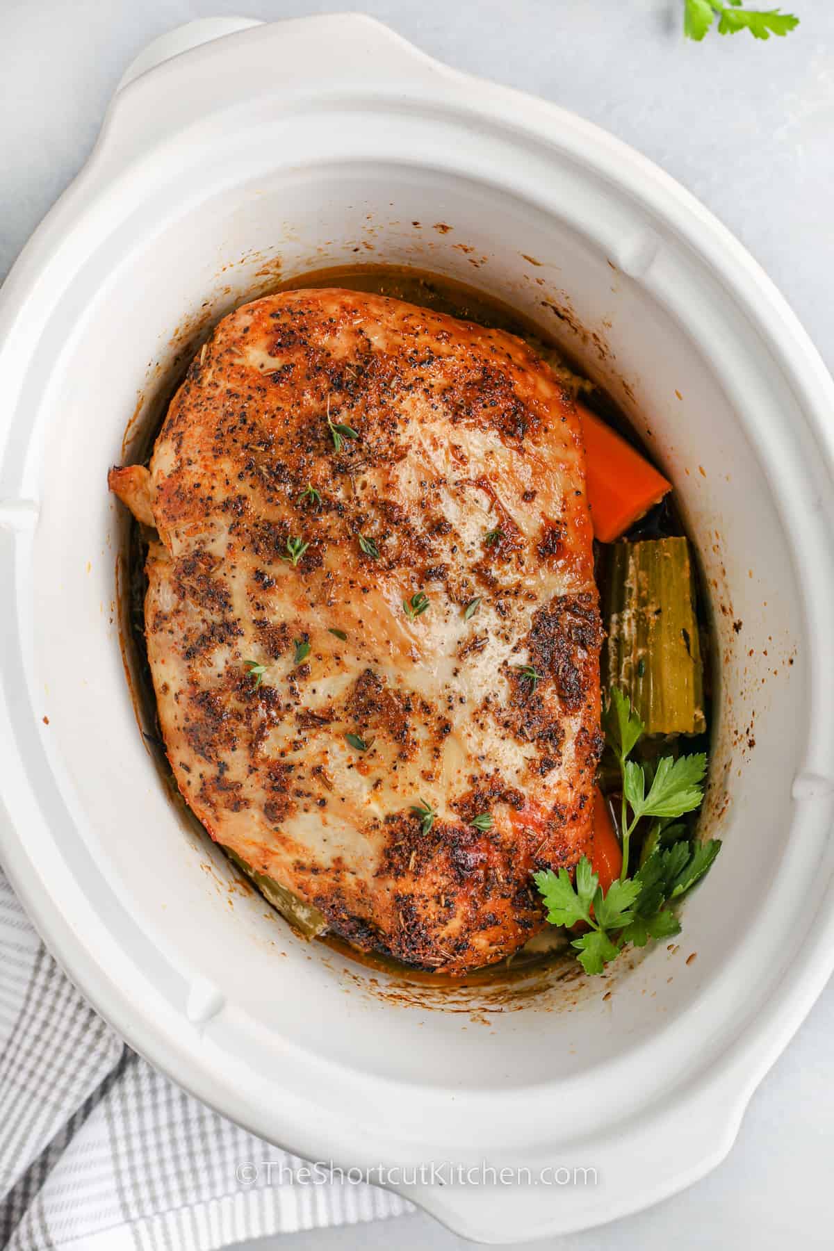 whole crockpot turkey breast in a crockpot with veggies