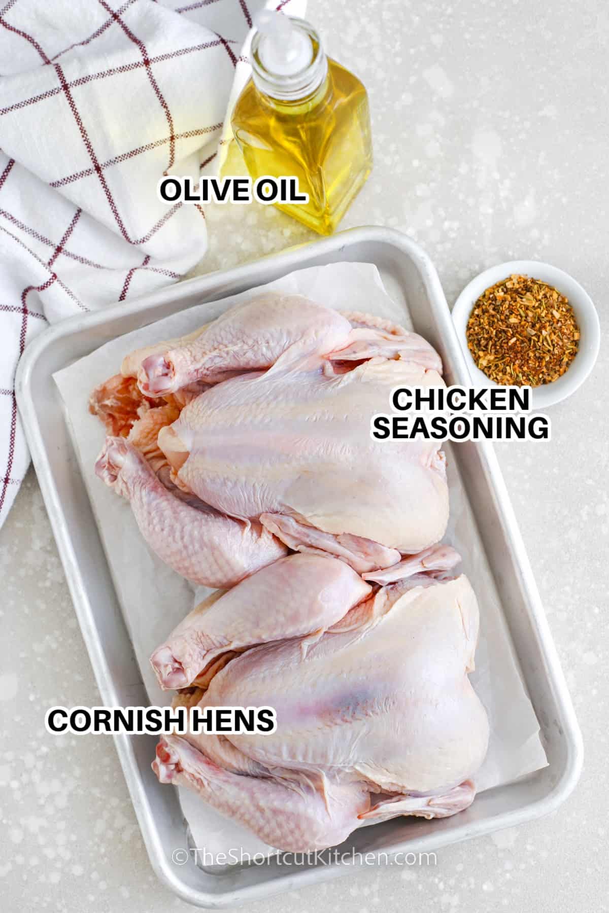 Ingredients to make baked cornish hen labeled: olive oil, chicken seasoning, and cornish hens