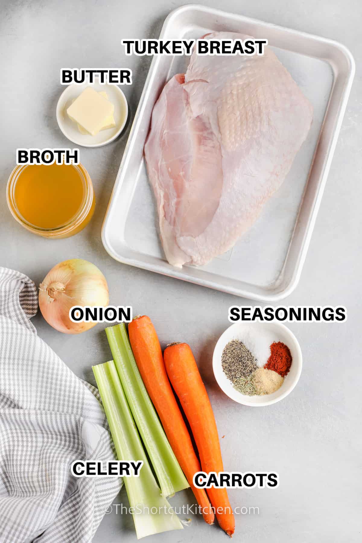 ingredients for crockpot turkey breast including turkey breast, butter, broth, onion, seasonings, carrots, and celery
