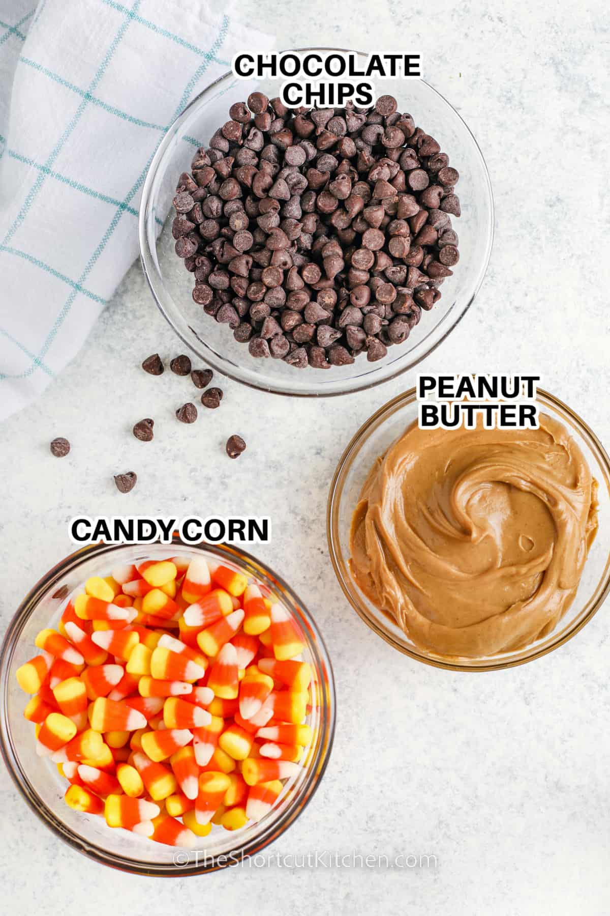 ingredients to make homemade butterfinger including chocolate chips, candy corn, and peanut butter