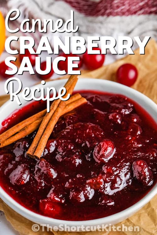 A serving dish of canned cranberry sauce with cinnamon sticks and a title
