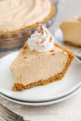 a slice of no bake pumpkin pie with whipped cream and cinnamon on top