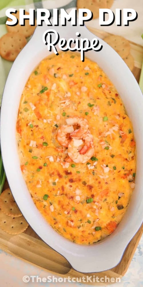 Shrimp dip in a white oval bowl garnished with shrimp on top, with a title