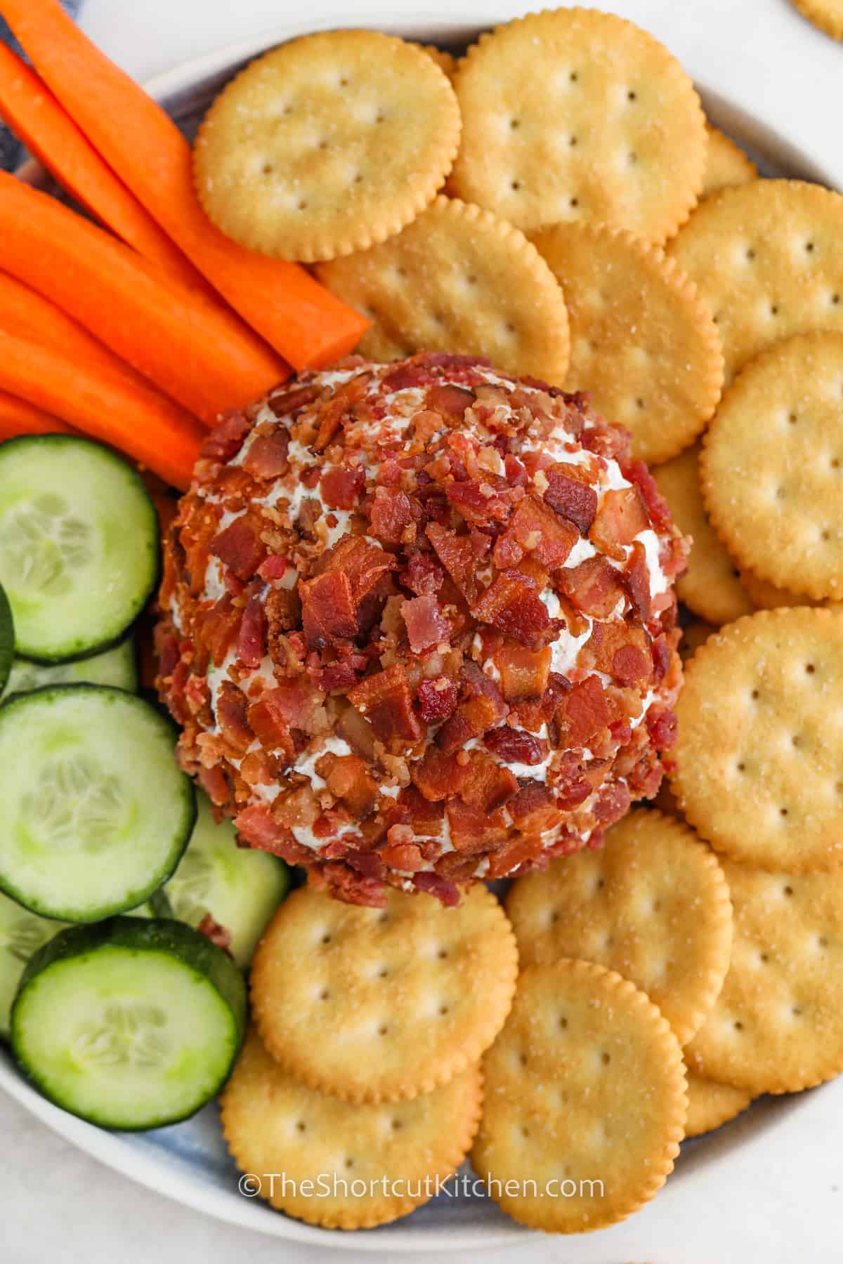 Bacon Ranch Cheese Ball on a serving plate with dippers