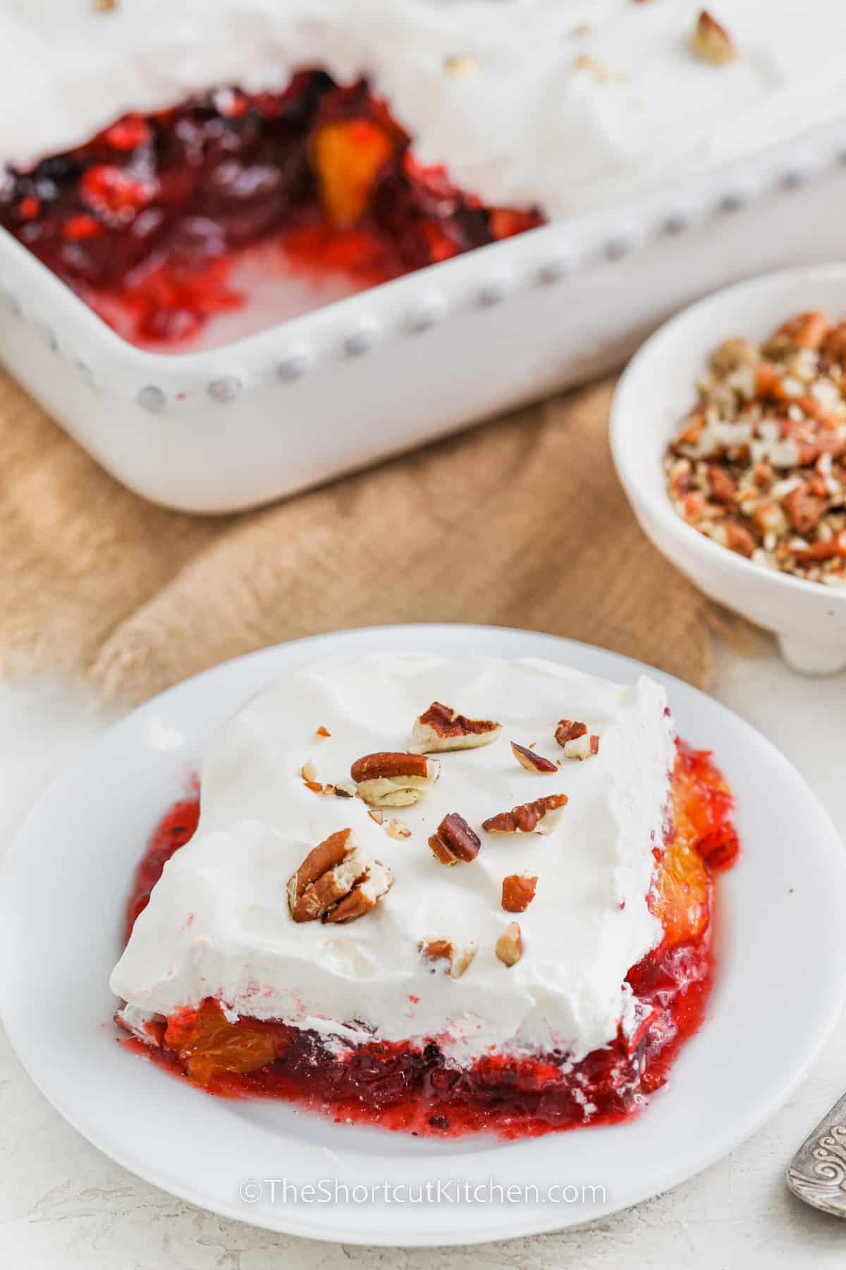 square of cranberry jello salad on a white plate