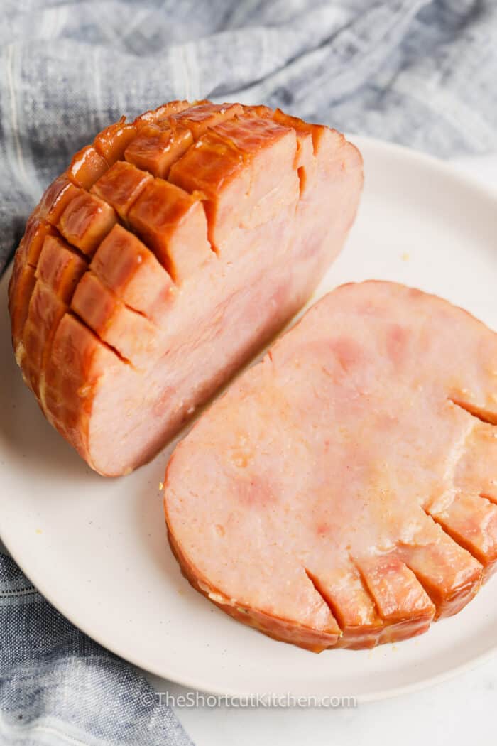 sliced Crockpot brown sugar ham on a white plate