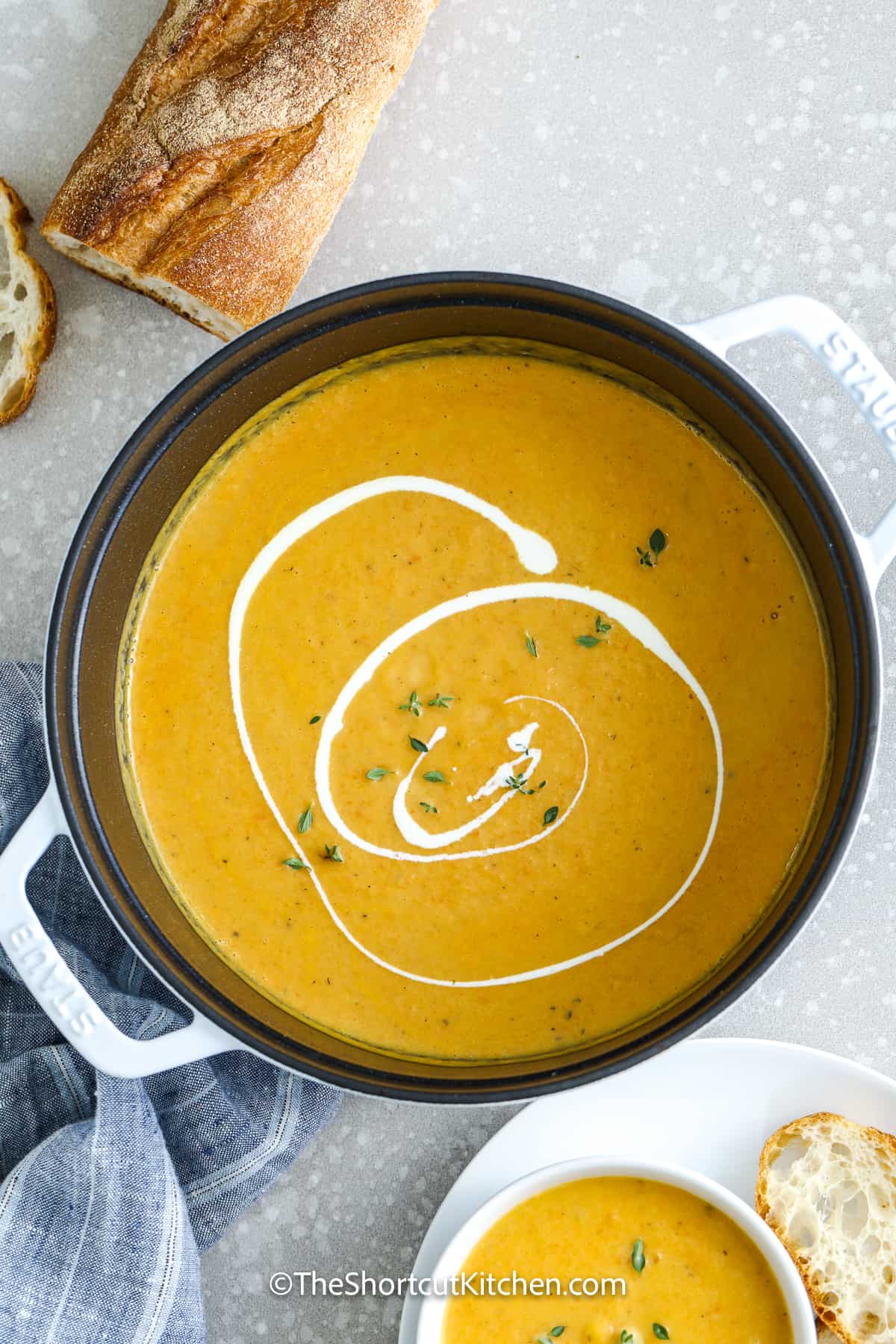 easy butternut squash soup drizzled with cream