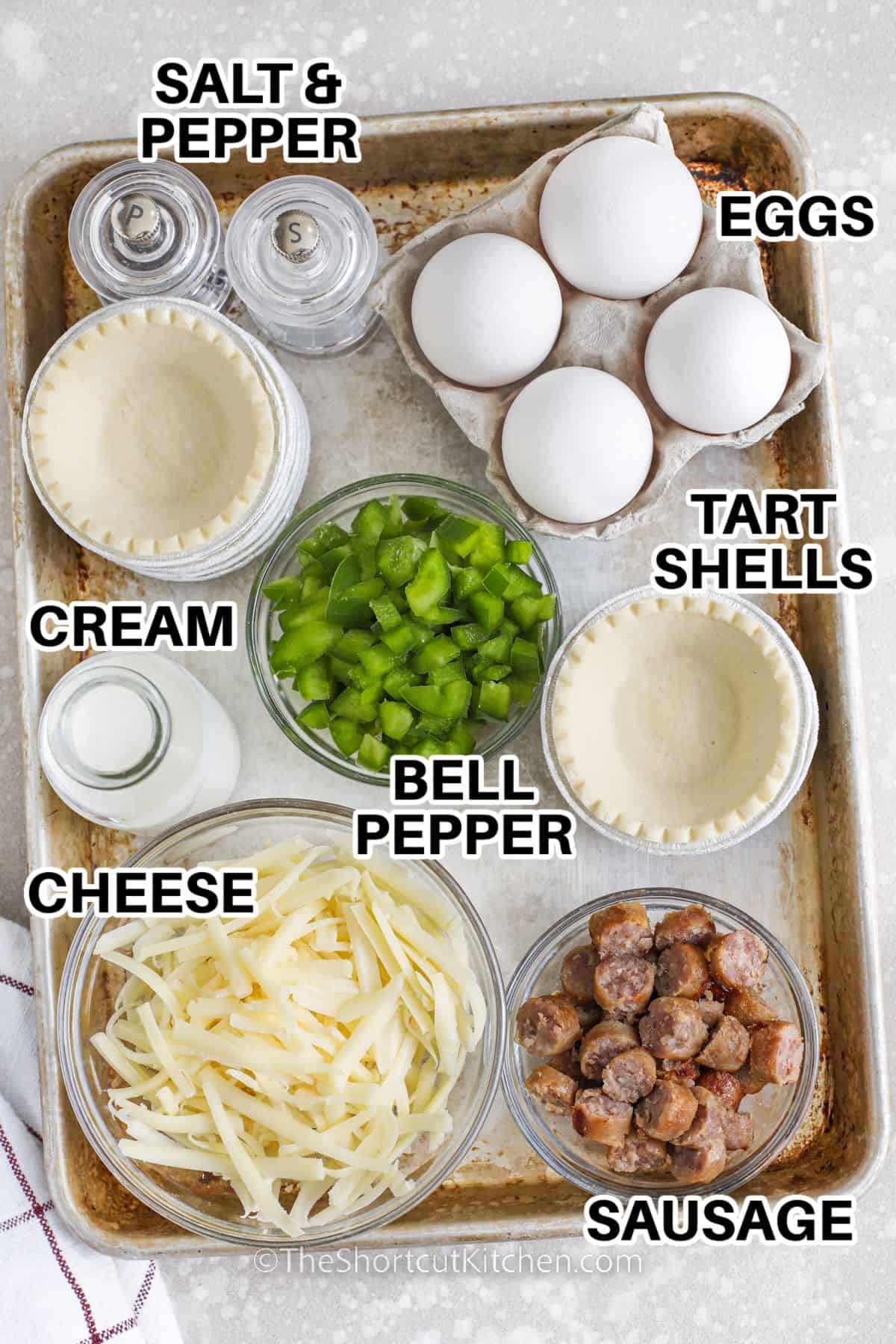 eggs , cream , tart shells , bell pepper, salt and pepper , cheese and sausage with labels to make Mini Quiche Recipe