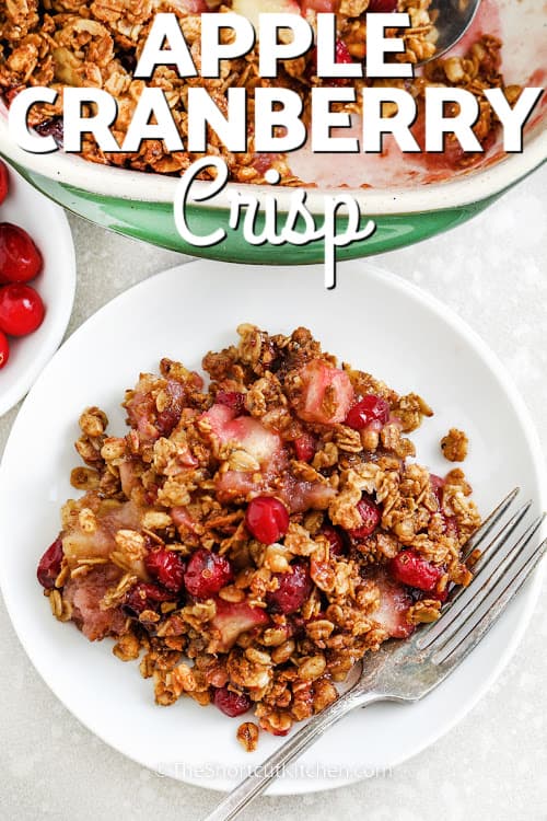 apple cranberry crisp on a plate with a fork and a title