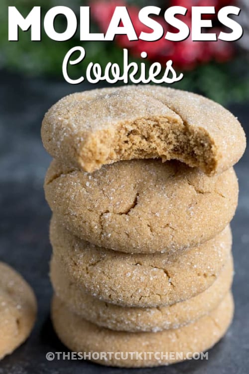 stack of molasses cookies with a bite taken out of the top one and writing