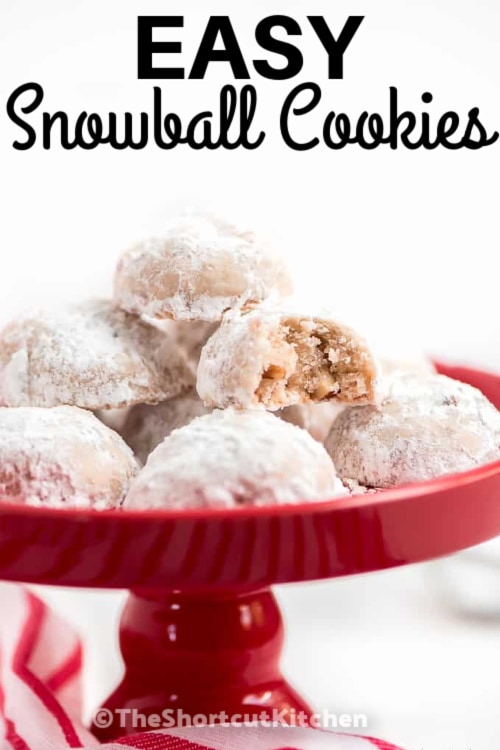 snowball cookies on a red plate with writing