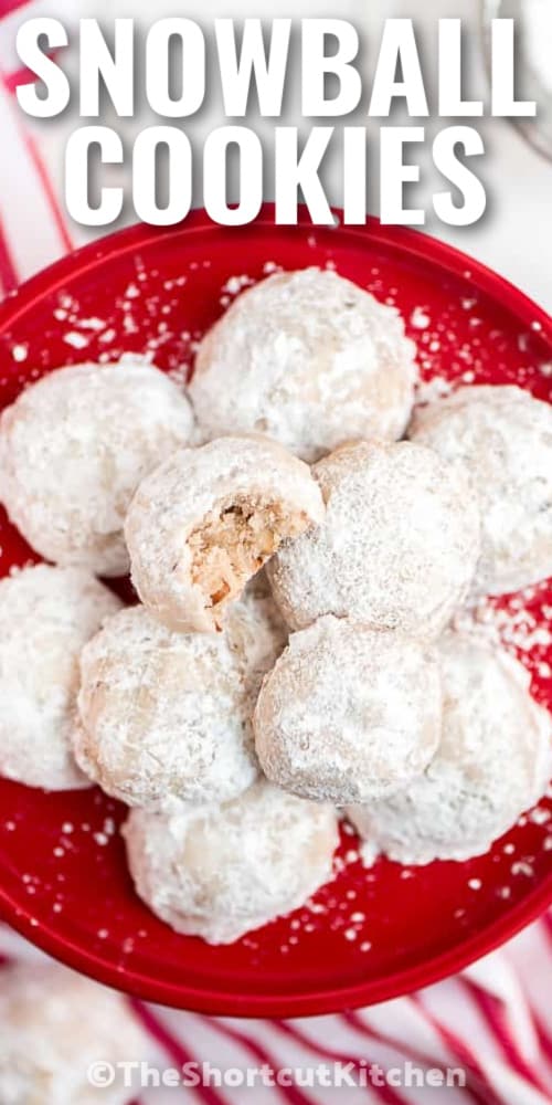 snowball cookies on a red plate with a title