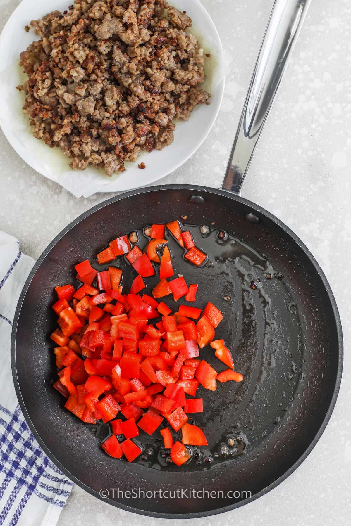 diced red peppers cooking in a pan