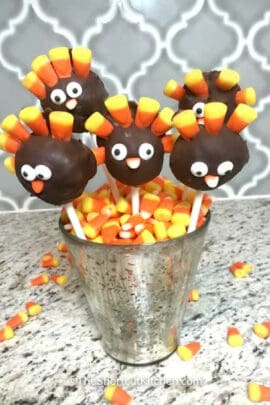 Thanksgiving cake pops sticking up in a jar of candy corn