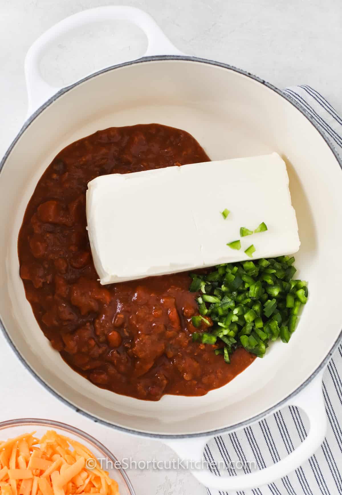 adding ingredients to pot to make Chili Cheese Dip Recipe