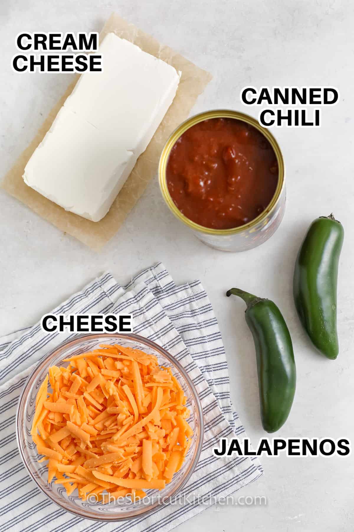 cream cheese , canned chilli , jalapeños and cheese with labels to make Chili Cheese Dip Recipe