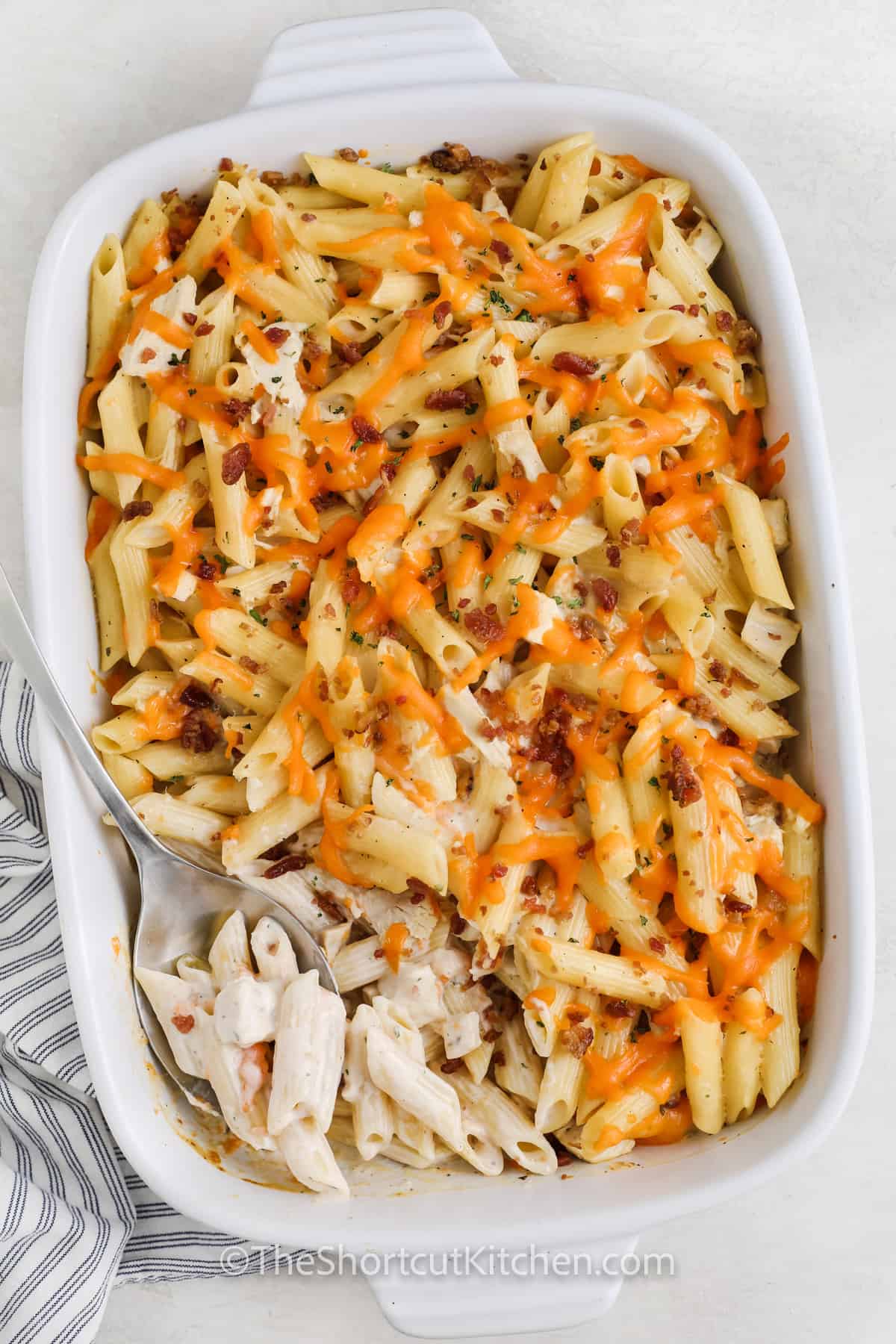 baked Chicken Bacon Ranch Pasta in the dish with a spoon