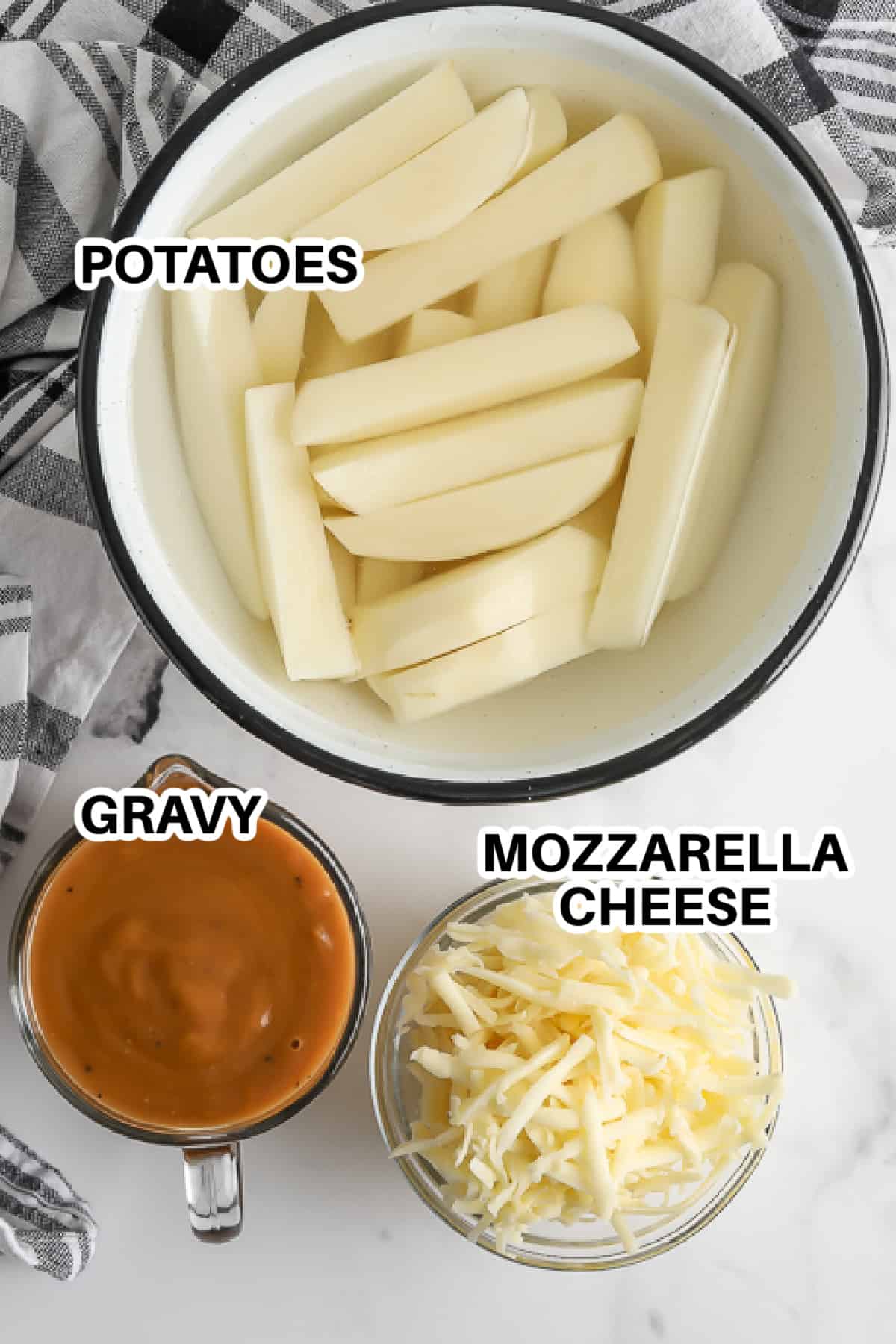 potatoes, gravy and mozzarella cheese assembled to make disco fries.