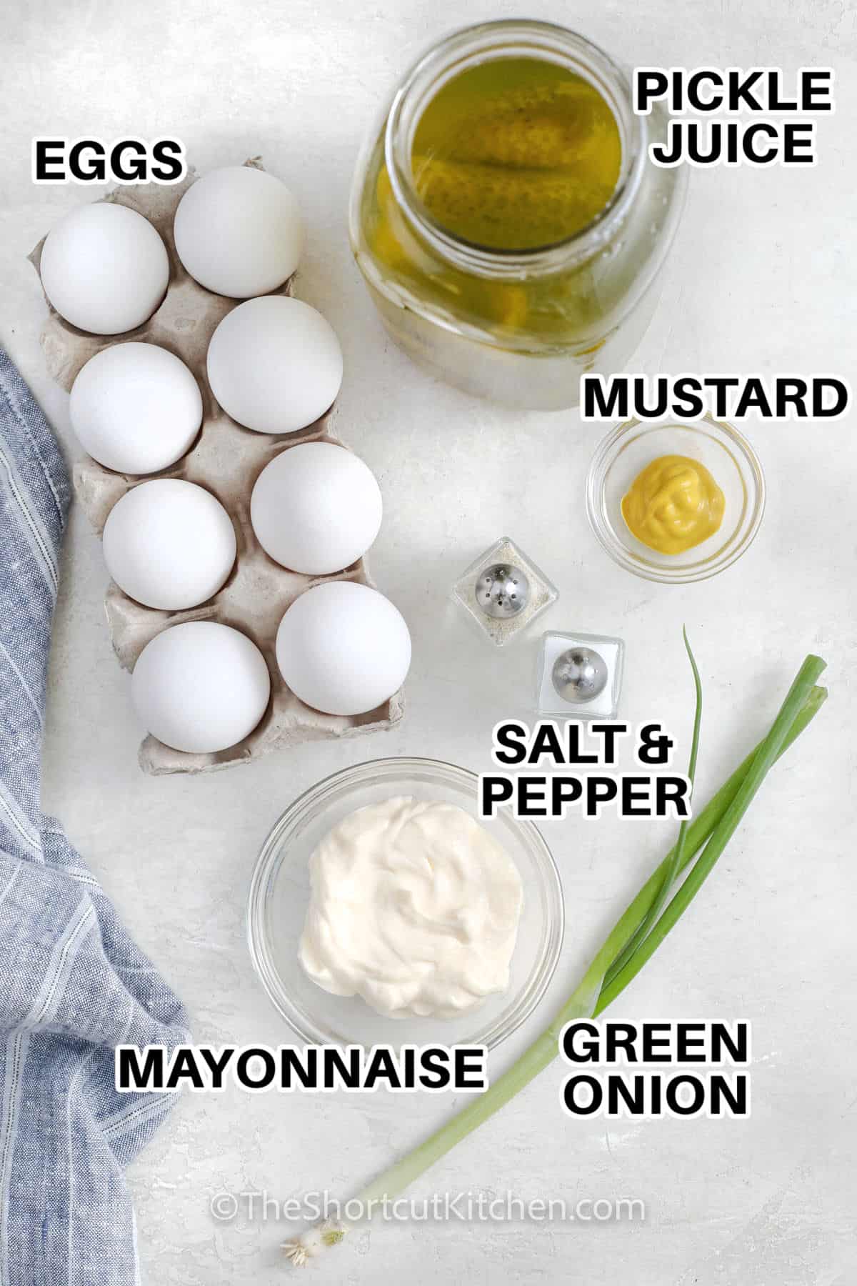 eggs, pickle juice, mustard, green onion, mayonnaise, eggs, salt and pepper assembled to make easy egg salad recipe