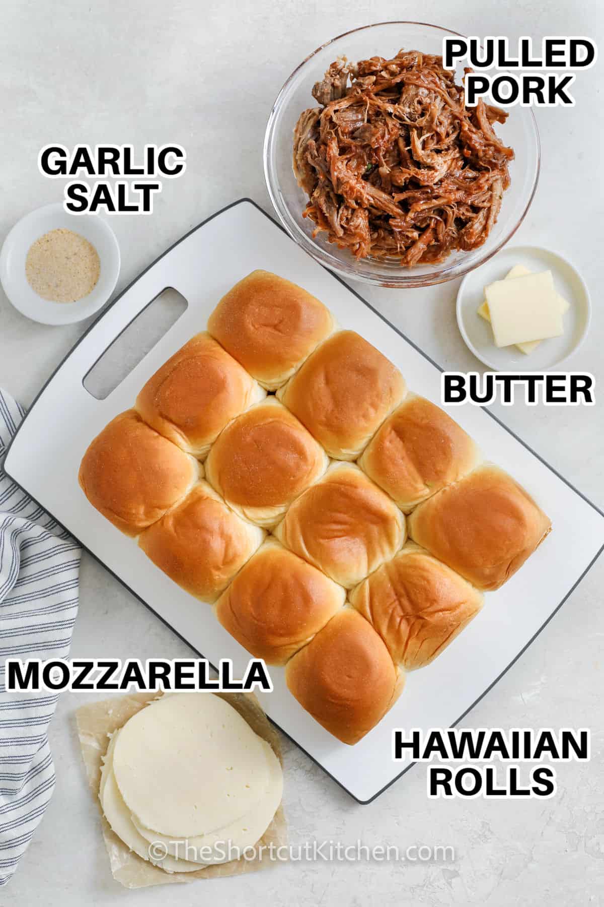 pulled pork , garlic salt , butter , mozzarella , Hawaiian rolls with labels to make Pulled Pork Sliders