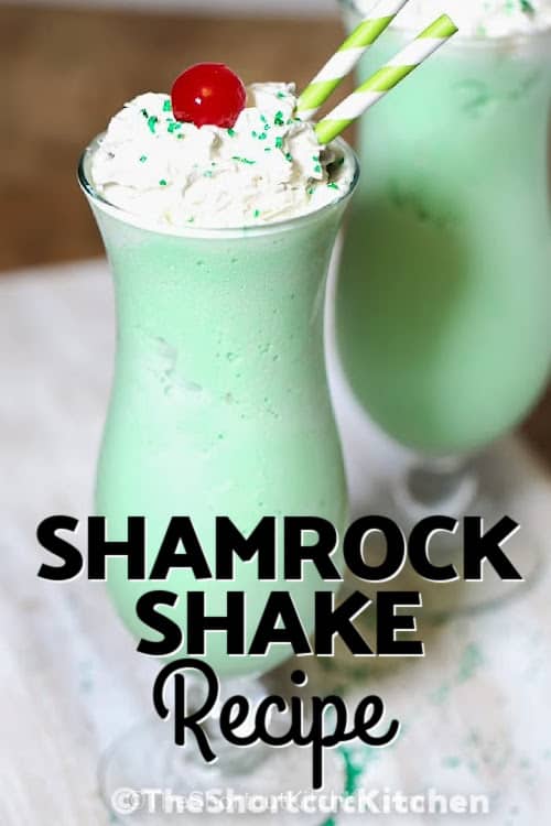 shamrock shake in a cup with whipped cream and a cherry on top with a title