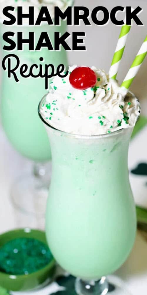 shamrock shake in a cup with whipped cream, two straws, and a cherry on top with text
