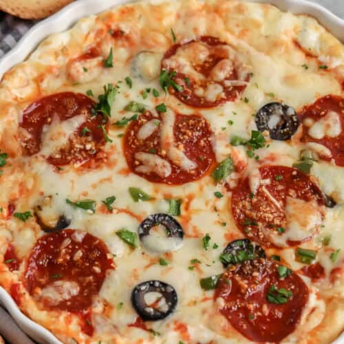 bowl of Cheesy Pizza Dip with bread pieces around it